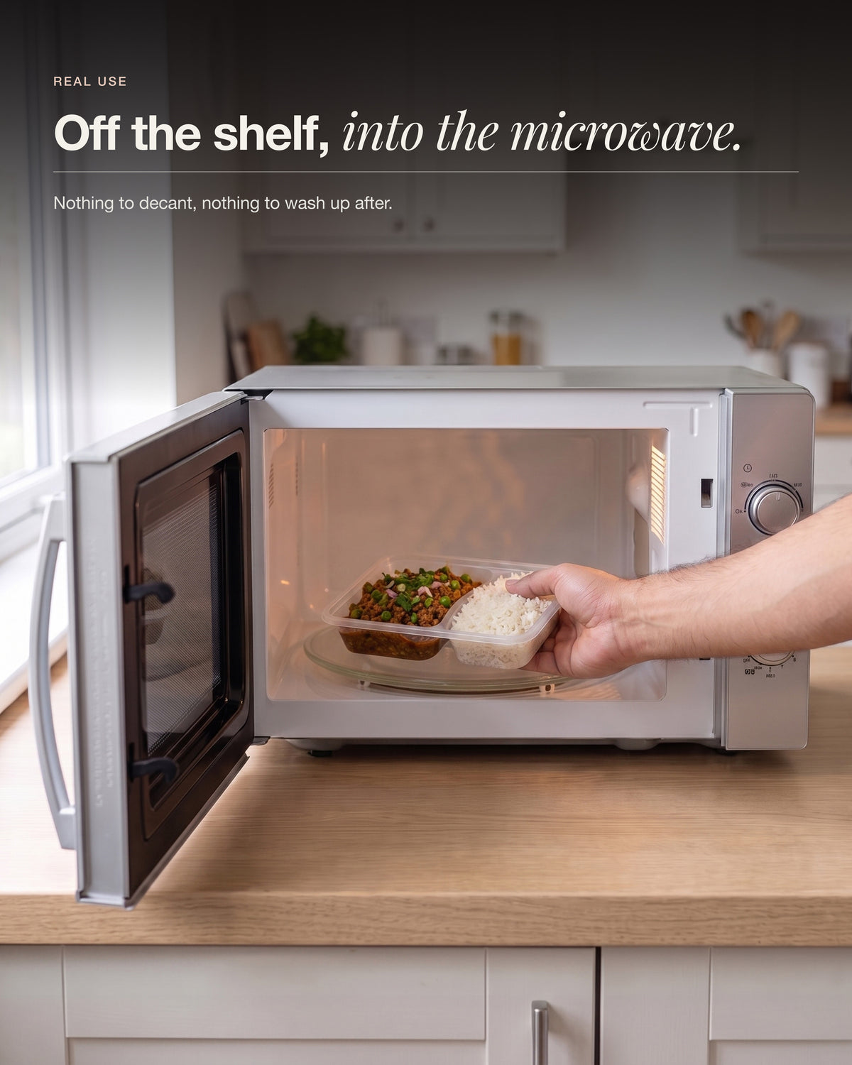Chicken Keema Breakfast Bowl, pack going into a home microwave, tray and rice compartment visible, two minutes to heat