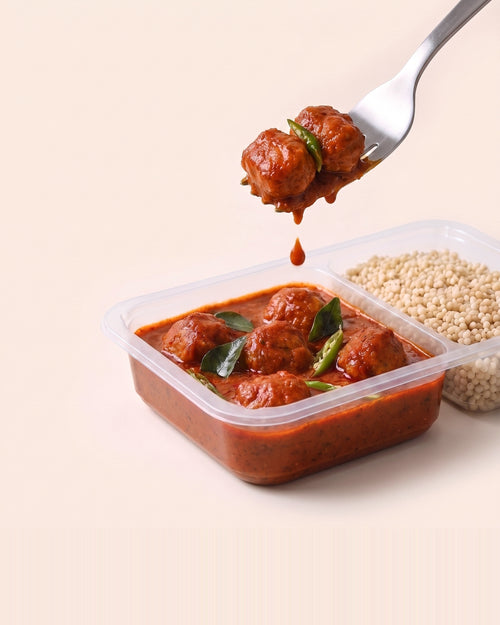 Andhra Chilli Soya, a forkful lifted from the open tray, soya in Andhra chilli gravy beside pearl millet