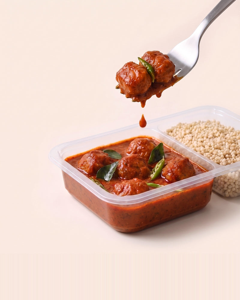 Andhra Chilli Soya, a forkful lifted from the open tray, soya in Andhra chilli gravy beside pearl millet