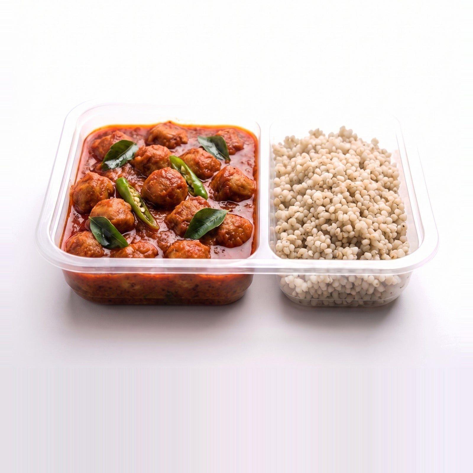 Andhra Chilli Soya, the open tray with soya in Andhra chilli gravy beside pearl millet