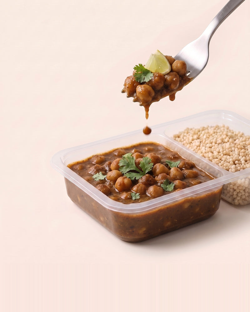 Punjabi Chole Bowl, a forkful lifted from the open tray, chole beside pearl millet