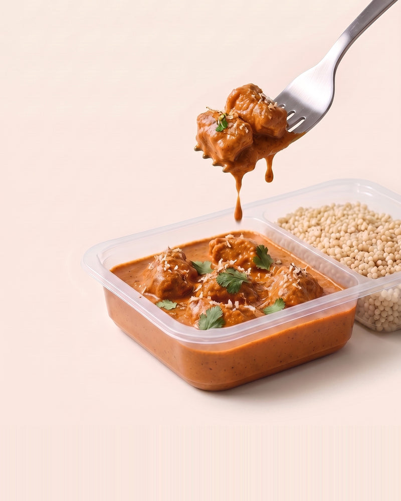 Kolhapuri Chicken Bowl, a forkful lifted from the open tray, Kolhapuri gravy beside pearl millet