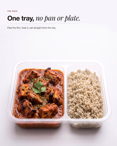 Chicken Tikka Masala in its two compartment tray, curry beside pearl millet